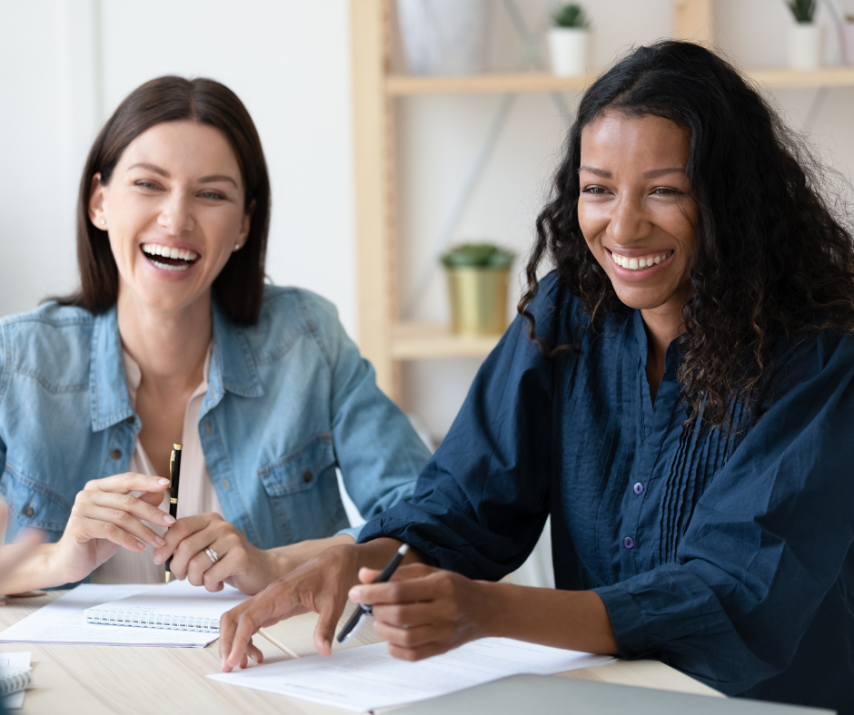 two women smiling at work