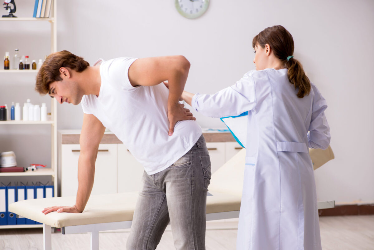 Close-up of a massage therapist applying deep tissue pressure to a client's shoulder muscles